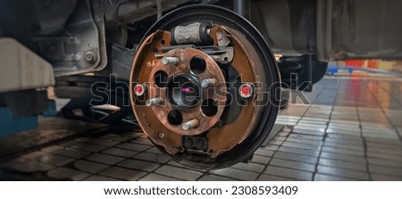 Maintenance repair and cleaning drum brake and asbestos brake pads it's a part of car use for stop the car for safety at rear wheel this a new spare part for repair at car garage free image