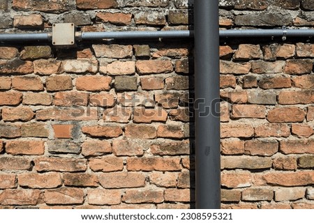 Brick  wall with tubes on it