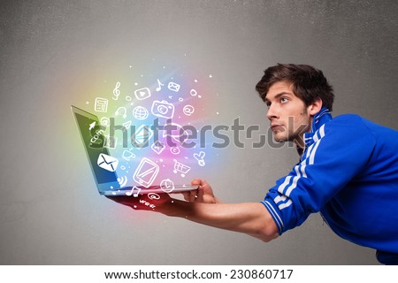 Casual young man holding laptop with colorful hand drawn multimedia symbols