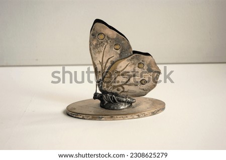 Silver letter holder in the shape of a butterfly. Art nouveau early 1900. Royalty-Free Stock Photo #2308625279