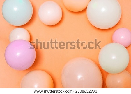 Border of colorful balloons on the orange background