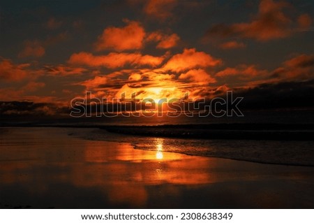 Sunrise shining through the clouds on Pine Knoll Shores, North Carolina Royalty-Free Stock Photo #2308638349