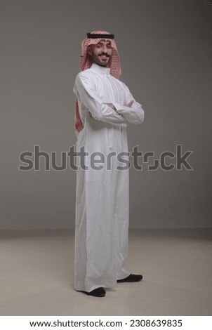 A saudi character wearing thob standing on withe background Royalty-Free Stock Photo #2308639835