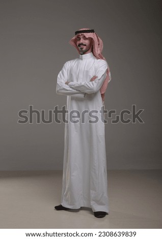 A saudi character wearing thob standing on withe background Royalty-Free Stock Photo #2308639839
