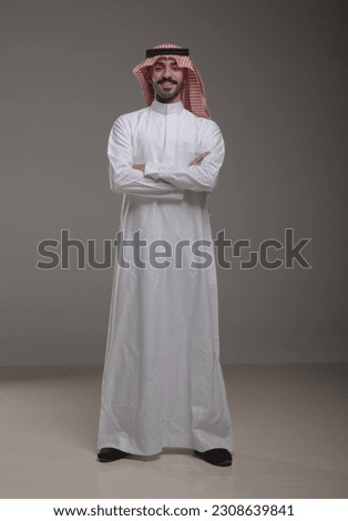 A saudi character wearing thob standing on withe background Royalty-Free Stock Photo #2308639841