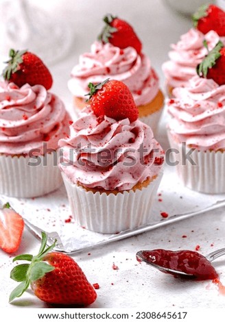 Pink strawberry cream cupcake on tray Royalty-Free Stock Photo #2308645617