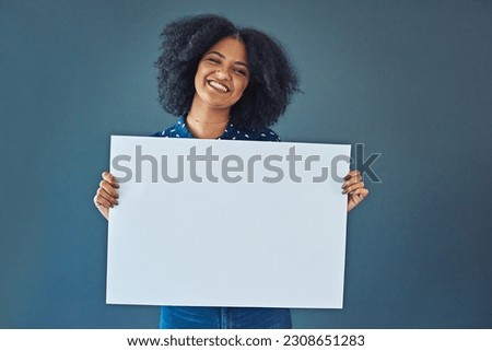 Happy, mockup and portrait of a woman with a sign isolated on a blue background in studio. Smile, showing and young corporate copywriter with a blank board for branding, design and information space