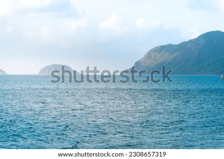a peaceful Con Dao island, Vietnam is a Vietnamese island heaven. Coastal view with waves, coastline, clear sky and road, blue sea, tourists and mountain. Travel and landscape concept.