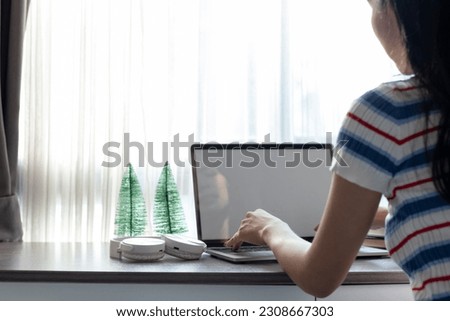 Young women work from home and use laptop computers to search for information and communicate with colleagues to work online. The concept of working from home with Notebook via online system.