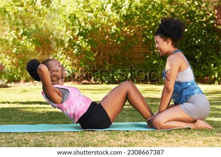 Woman helps her friend with sit up crunches, assist in park, fitness buddy Royalty-Free Stock Photo #2308667387