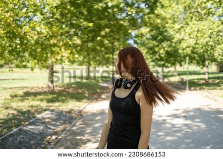 Young woman with photo camera in park