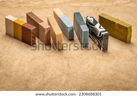 variety of 7 organic, artisan soap bars on a textured bark paper Royalty-Free Stock Photo #2308688301