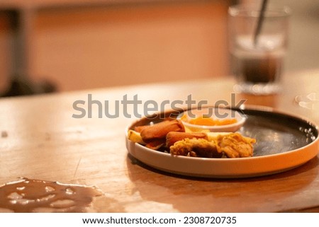 Mix platter with french fries, chicken nugget, sausage and tomato sauce close up photo