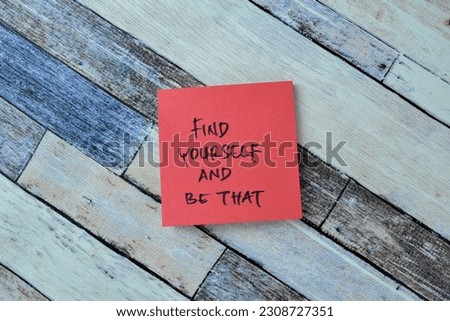 Concept of Find Yourself and Be That write on sticky notes isolated on Wooden Table.
