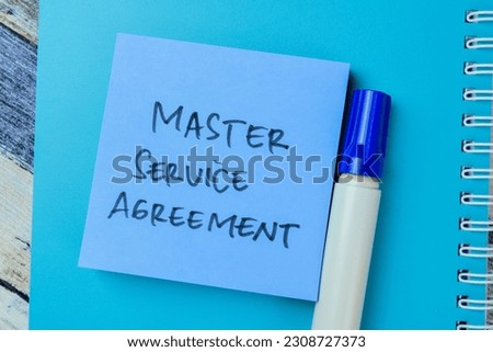 Concept of Master Service Agreement write on sticky notes isolated on Wooden Table.