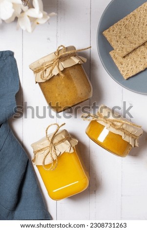 Jars with honey and nuts honey on wooden background top view, flat lay.