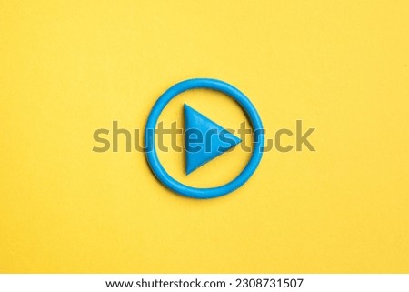  3d simple play button, 3d media play sign on yellow background. Plasticine object.