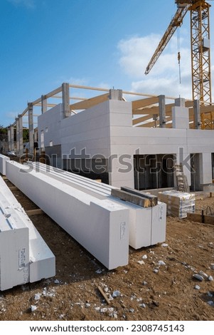 A new factory building is erected on a construction site  Royalty-Free Stock Photo #2308745143