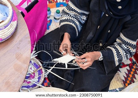 Saudi woman wearing traditional cloth and doing hand made craft products. Riyadh Saudi Arabia. Royalty-Free Stock Photo #2308750091