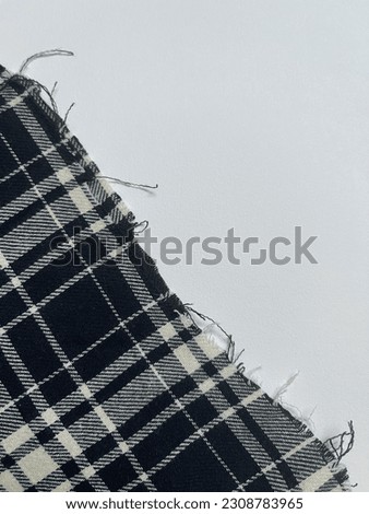 Closeup of frayed edge of plaid fabric Royalty-Free Stock Photo #2308783965