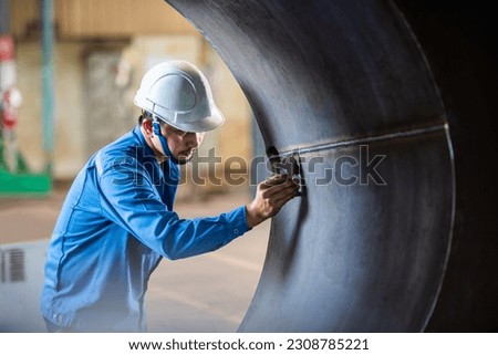 QC Technician inspector using welding gauge inspection butted weld on plate steel structure in industry fabrication factory. NDT Royalty-Free Stock Photo #2308785221