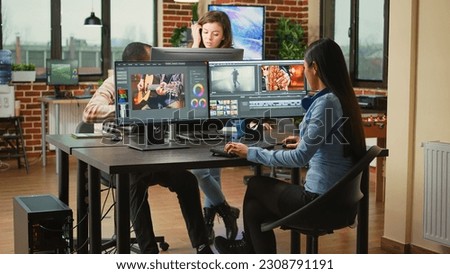 Videography expert editing video footage in post production agency house, improving montage quality on creative software. Video editor working on movie or film lighting, filmmaking industry. Royalty-Free Stock Photo #2308791191