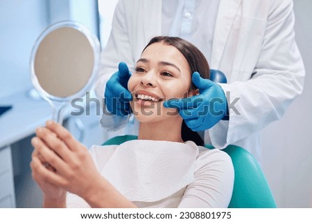 Dentist, mirror and woman check smile after teeth cleaning, braces and dental consultation. Healthcare, dentistry and happy female patient with orthodontist for oral hygiene, wellness and cleaning Royalty-Free Stock Photo #2308801975