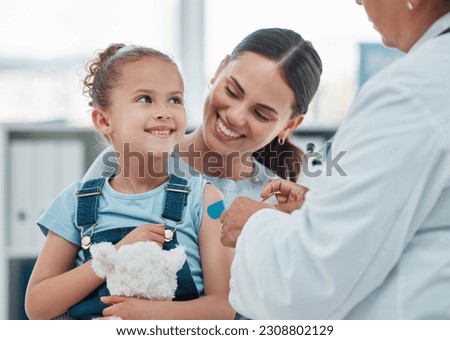 Girl, mom and doctor with vaccine injection, cotton ball and flu shot on arm for disease or covid prevention in hospital. Woman, nurse and child with pediatrician help with bandaid, teddy or health Royalty-Free Stock Photo #2308802129