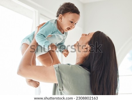 Mother holding laughing baby in home for love, care and quality time together to nurture childhood development. Happy mom, carrying and playing with infant girl kid for support, happiness and fun Royalty-Free Stock Photo #2308802163