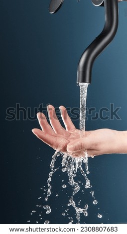 The faucet is pouring water, and the picture of catching the water with the hand,value water resource
