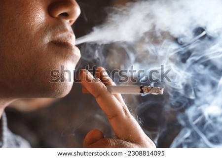 man smoking a cigarette. Cigarette smoke spread.  Royalty-Free Stock Photo #2308814095