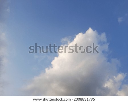 White clouds drifting in summer blue sky.