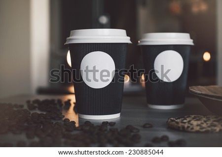 Blank paper cup of coffee in a coffee shop for the application logo Royalty-Free Stock Photo #230885044