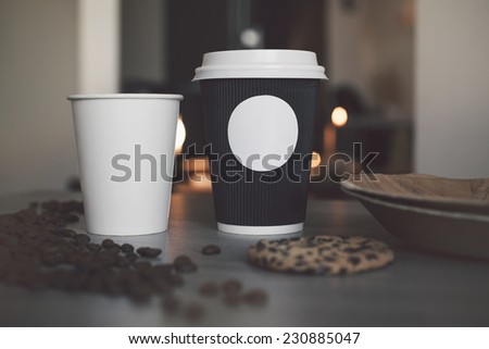 Blank paper cup of coffee in a coffee shop for the application logo Royalty-Free Stock Photo #230885047