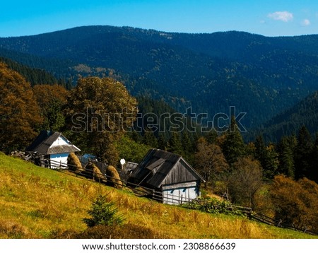 lodge in the mountains with bales of hay in the yard. High quality photo