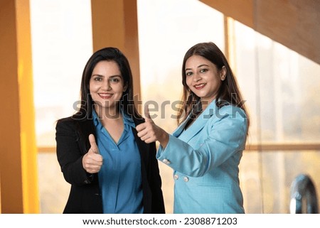 Indian corporate women showing thumps up at office Royalty-Free Stock Photo #2308871203