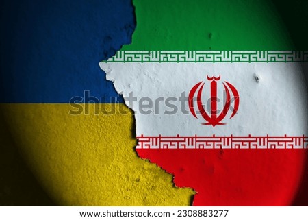 Ukraine flag and iran flag painting on wall. Ukraine vs iran.