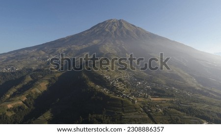 Drone aerial photo of Sumbing Mountain in the morning with the view of small village 