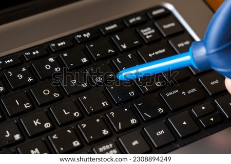 Clean your laptop keyboard with a blower