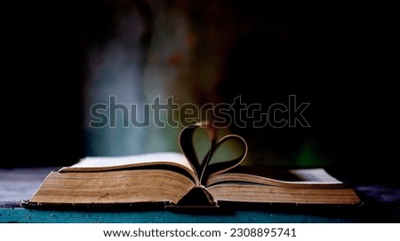 an old book of love poems with a heart between the pages Royalty-Free Stock Photo #2308895741