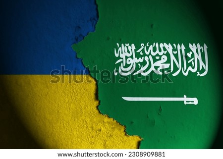 Ukraine flag and saudi arabia flag painting on wall. Ukraine vs saudi arabia