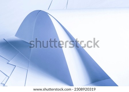 Large sheets of white paper in cold colors.