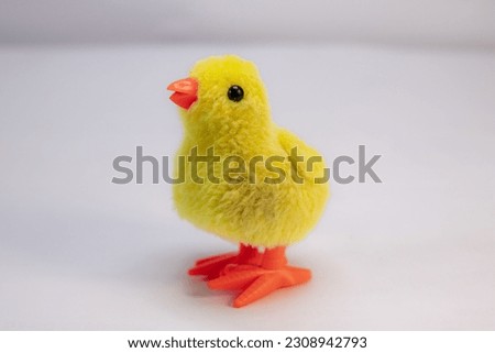 close-up walking yellow chicken toy for kids place on nice white background 