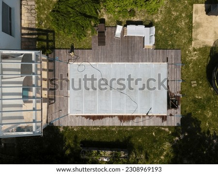 aerial drone photo of pool after winter, cleaning the plane, the pool, draining the dirty water, dirty pool before the spring
