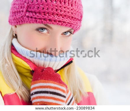Frozen beautiful woman in winter clothing outdoors