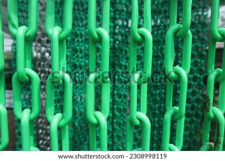 Green plastic chain barriers in the park