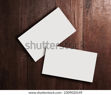 Business card blank on wooden texture in still life and dark tone