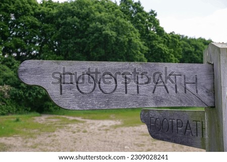 wooden post footpath sign. Directional  fingerpost on rural footpath