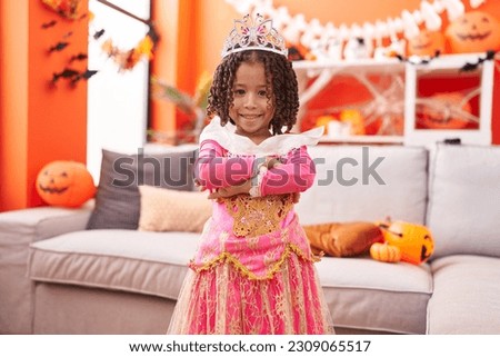 African american girl wearing princess costume standing with arms crossed gesture at home Royalty-Free Stock Photo #2309065517