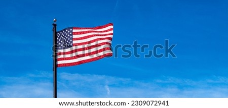 American Flag Waiving in Blue Sky with Light Clouds Royalty-Free Stock Photo #2309072941